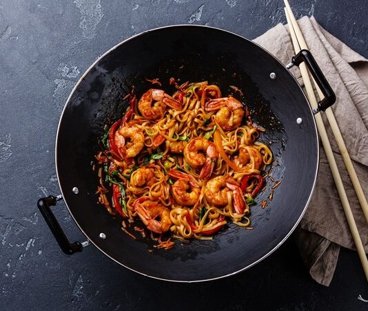 Woklama Tekniği Dünya Mutfağında Yükselen Bir Trend Woklama, kökeni Çin mutfağına dayanan ve asırlardır kullanılan bir pişirme tekniğidir. Yüksek ateş ve özel tasarlanmış derin tavalarda yapılan bu yöntem, kısa sürede yüksek ısı ile yemeklerin hazırlanmasını sağlar. Bu teknik, sadece hız değil aynı zamanda malzemelerin tazeliğini ve besin değerini korumasıyla da öne çıkar. Özellikle sebzelerin parlak rengini, etlerin ise sulu dokusunu koruyabilmesi, woklamanın diğer pişirme yöntemlerinden ayrılmasını sağlar. Konulu bir haber görseli.